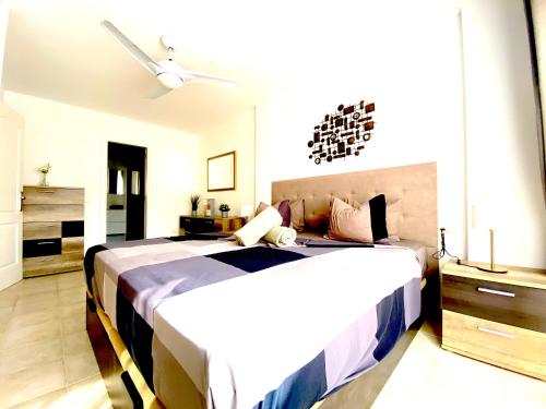 a bedroom with two beds and a ceiling fan at Duquesa del Mar in San Miguel de Abona