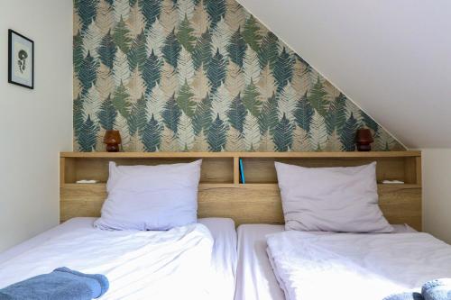 a bed with two pillows sitting next to each other at Pod Špičákem in Smržovka