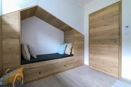 a room with a built in bench with pillows at Pod Špičákem in Smržovka