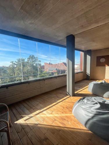 a bedroom with a large window with a view of the city at Kotimaailma - Premium 2 bedroom apartment with Terrace & Sauna in Vantaa
