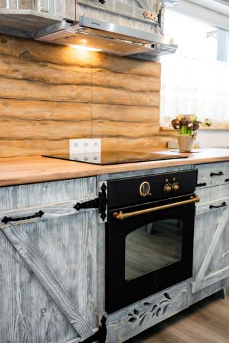 a kitchen with a black oven on a counter at Kata Kulcsosház in Odorheiu Secuiesc
