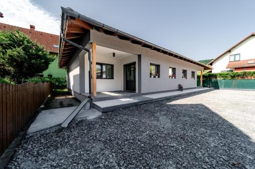 a house with a driveway in front of it at Kata Kulcsosház in Odorheiu Secuiesc