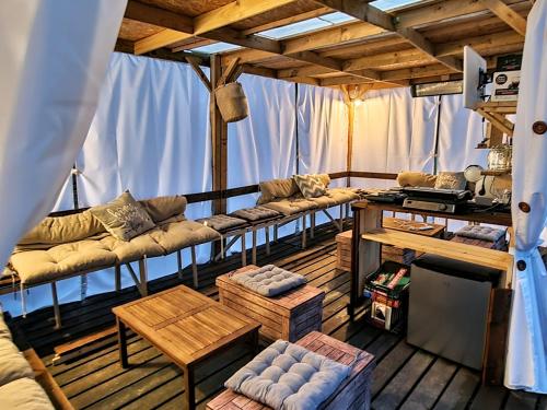 a living room with couches and tables in a room at Agriturismo Rosa Antica in Monte San Vito