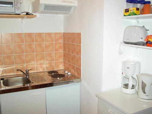 a small kitchen with a sink and a counter top at Ferienwohnung im Ostseeblick in Wismar