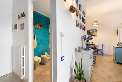 a bathroom and a room with a toilet and a sink at Attico con terrazza a Viareggio in Viareggio