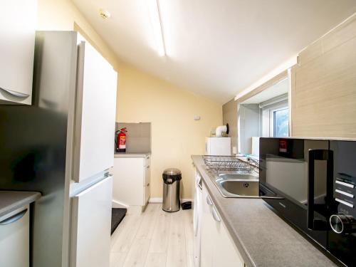 a kitchen with a sink and a counter top at Spacious Well Equipped Flat - Pass the Keys in Gosforth
