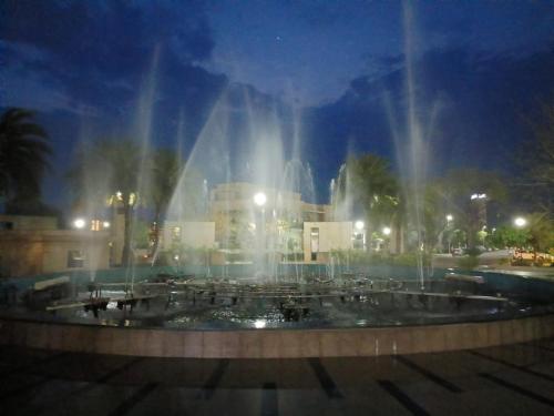 a fountain in a city at night with lights at Radhe Krishna Luxury stay in Mathura