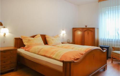 a bedroom with a bed with an orange comforter at Amazing Apartment In Lage With Wifi in Lage
