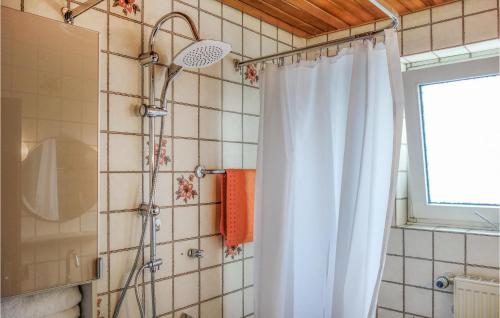 a shower with a white shower curtain in a bathroom at Amazing Apartment In Lage With Wifi in Lage