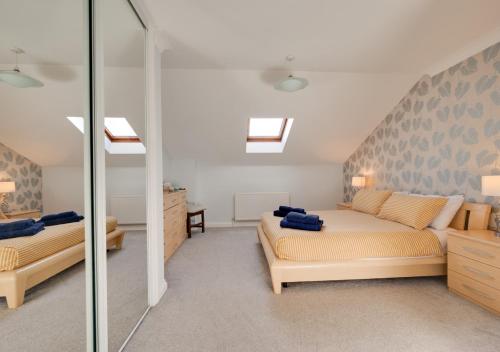 a bedroom with a bed and a glass wall at 4 Hesketh Mews in Torquay