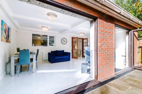 an open living room and dining room with a brick wall at 5 bed detached - Worsley, Manchester in Worsley