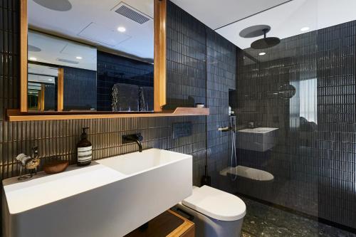 a bathroom with a sink and a toilet and a shower at Spire Residences by the Spire Manager in Brisbane