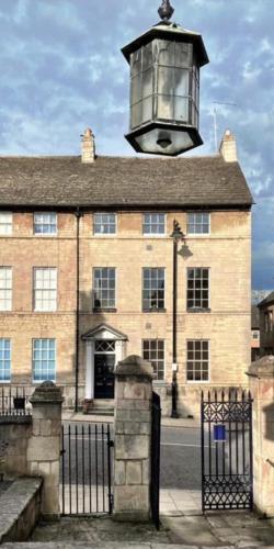 a large brick building with a lamp on top of it at Luxury apartment, 60 High St, St Martins in Lincolnshire