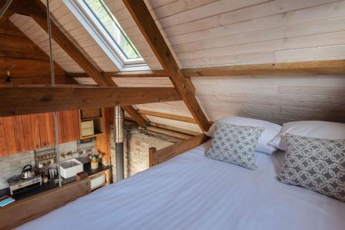 a bedroom with a large bed in a attic at Atlantis in Holbeton