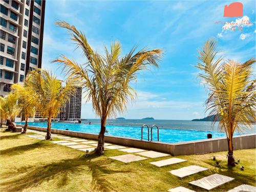 a pool with palm trees and a playground at Maison life 小居屋 Jesselton Quay CityPads in Kota Kinabalu