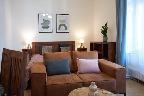 a living room with a couch and a bed at Narodni - Old Town Residence in Prague
