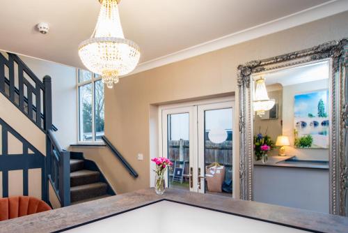 a dining room with a mirror and a table at Wilson Lodge in Maidenhead