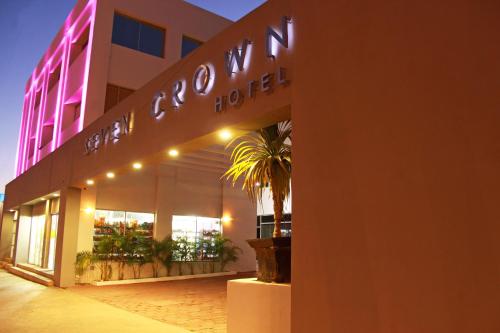 a hotel with a sign on the side of a building at Seven Crown Express & Suites by Kavia in Cabo San Lucas