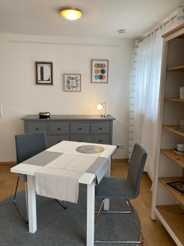 a dining room with a white table and chairs at Apartment Renz in Freudenstadt