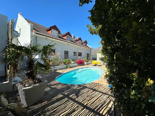 a swimming pool in the backyard of a house at Studio pool room in Hout Bay