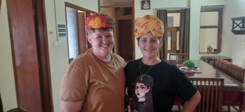 a man and a woman wearing paper hats on their heads at Beena Homestay in Jaipur