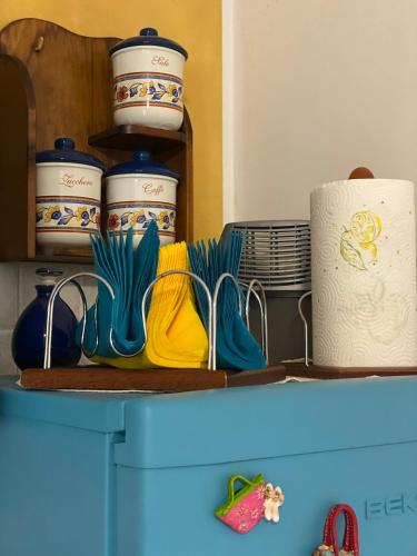 a shelf with plates and bowls on top of a refrigerator at Anna&Franco Guest House in Isernia