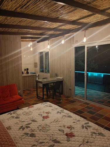 a living room with a ping pong table and a couch at Amonitas Glamping Deluxe in Tinjacá