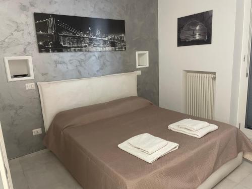a bedroom with a bed with two towels on it at San Donato Apartment in Barletta