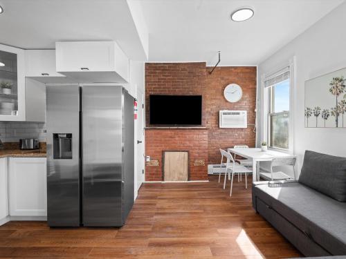 a kitchen and living room with a stainless steel refrigerator at Shadyside, Pittsburgh, Modern and Bright 1 Bedroom Unit4 with Free Parking in Pittsburgh