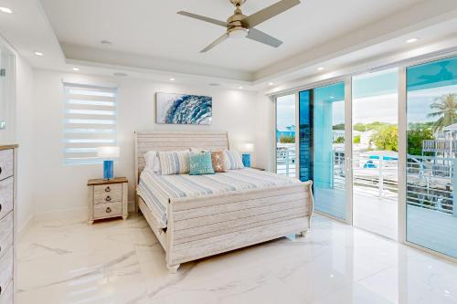 a bedroom with a bed and a ceiling fan at Afternoon Delight in Key Largo