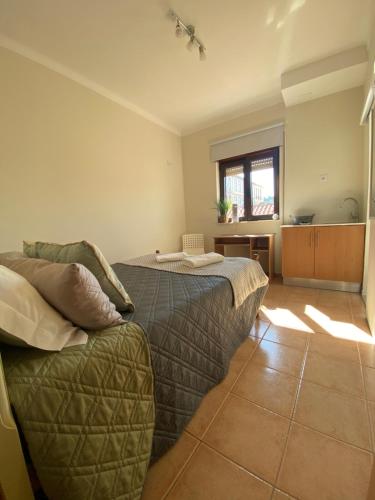 a bedroom with two beds and a couch at houses&halfhouses historic street in Caminha