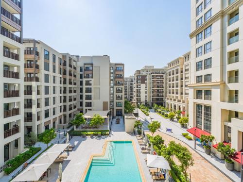 an aerial view of an apartment complex with a swimming pool at Dubai Creek Gem, Stylish Condo With Two Balconies in Dubai