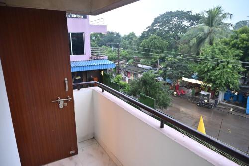 a room with a balcony with a view of a street at HOTEL SUN GREEN in Bhubaneshwar