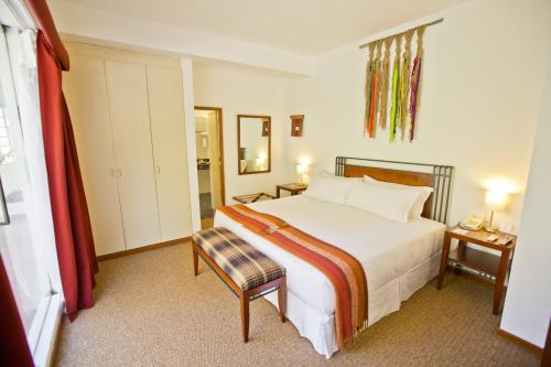 a hotel room with a bed and a chair at Tierra Viva Machu Picchu Hotel in Machu Picchu
