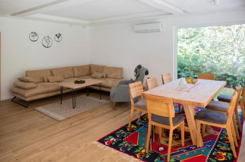 a living room with a table and a couch at Villa Rivus in Sarajevo