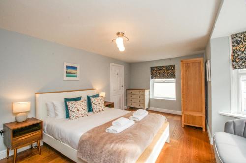 a bedroom with a large bed and a window at Bay Cottage in Weymouth