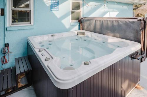 a large bath tub in a room with a bench at steve and cori's tropical king suite 2 in North Port