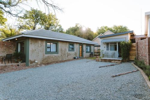 a house with a gravel driveway in front of it at River View in Potchefstroom