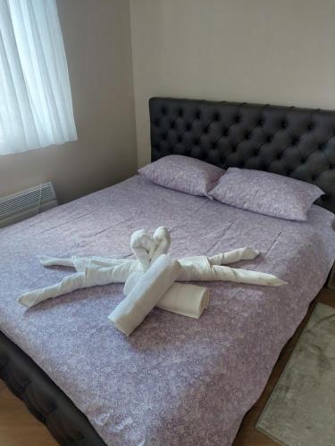 a group of white towels on a bed at Golden Apartman in Zlatibor