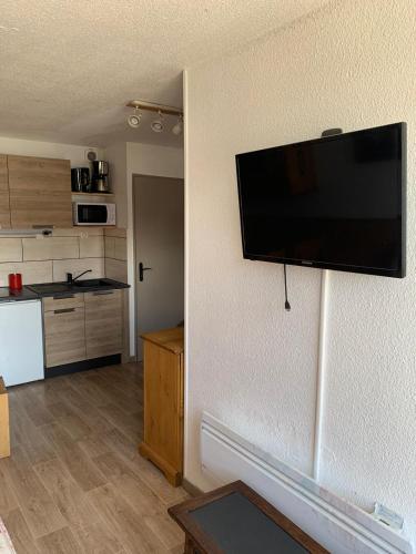 a living room with a flat screen tv hanging on a wall at ski-in ski-out 118 in Val Thorens