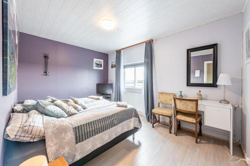 een slaapkamer met een bed, een bureau en een stoel bij MB Guesthouse in Grímsnes og Grafningshreppur