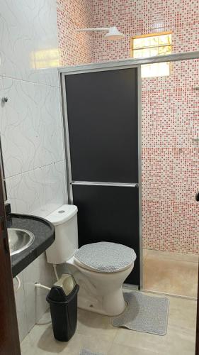 a bathroom with a toilet and a sink at Casa Amarela Alter in Alter do Chao