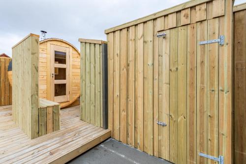 a row of wooden gates on a wooden deck at MB Guesthouse in Grímsnes og Grafningshreppur