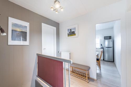 a living room with a red door and a kitchen at MB Guesthouse in Grímsnes og Grafningshreppur