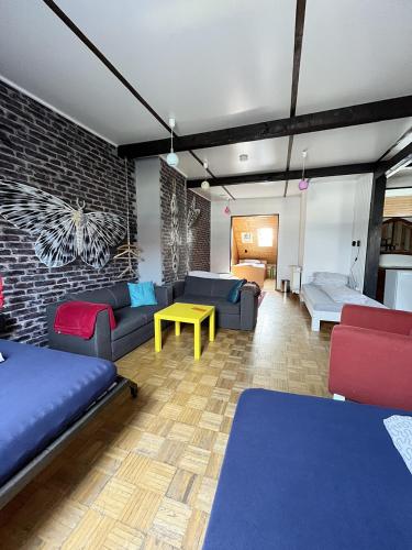 a living room with couches and a couch and a table at Homeplanet Hostel in Leipzig