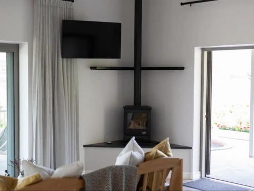 a living room with a couch and a fireplace at Latjeskloof Accommodation in Citrusdal
