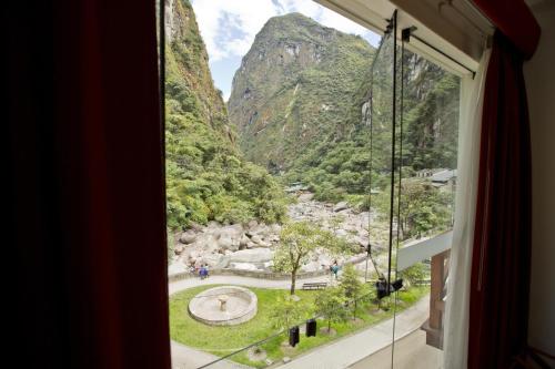 a window with a view of a mountain at Tierra Viva Machu Picchu Hotel in Machu Picchu