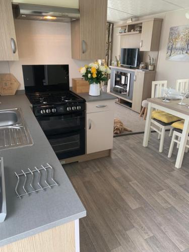 a kitchen with a stove and a counter top at Bude 13 in Cubert