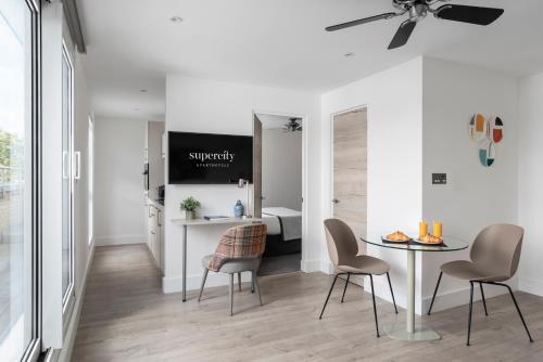 a room with a table and chairs and a bedroom at Q Square by Supercity Aparthotels in Brighton & Hove