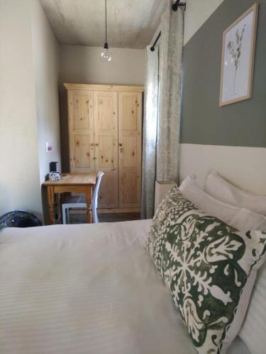 a bedroom with a bed and a table and a desk at River View in Potchefstroom